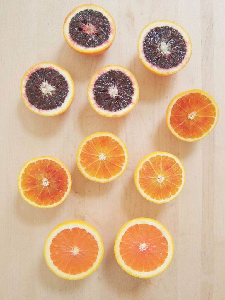 different colored blood oranges cut open