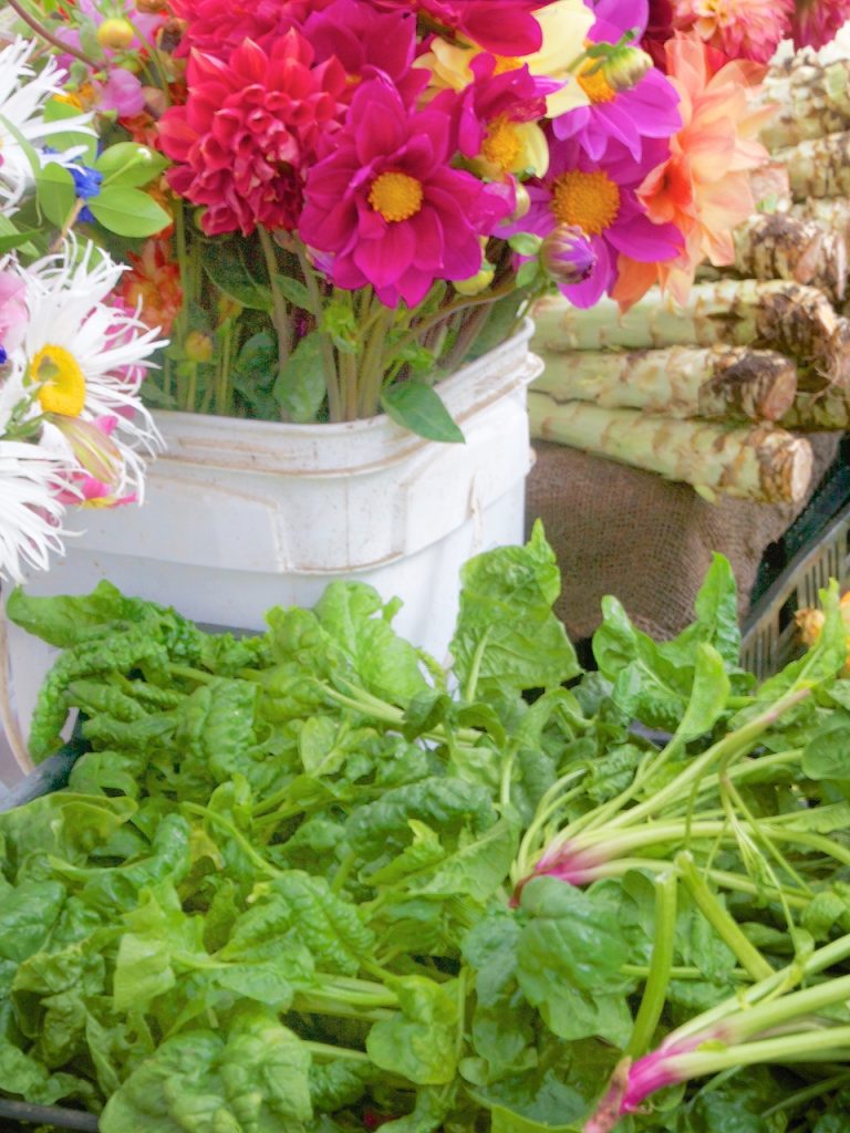 spinach and flowers in square bucket