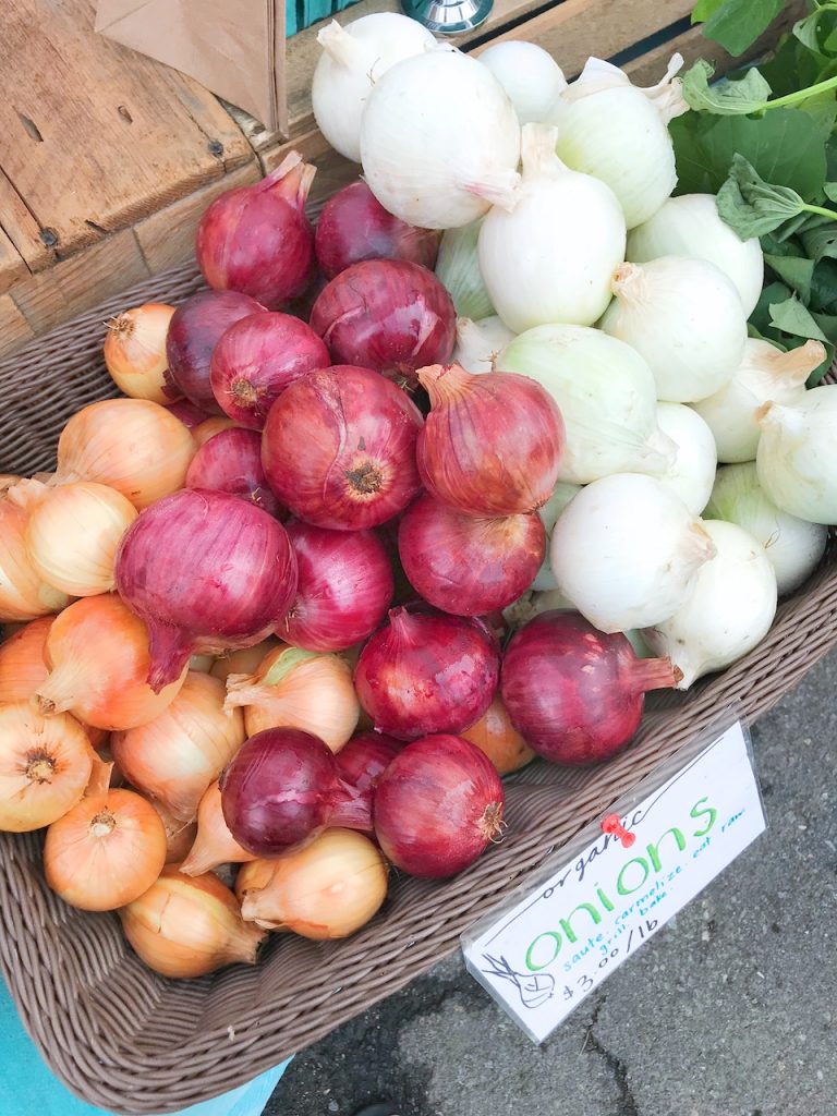 red onions at the farmers market