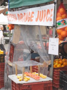 orange juice stand at farmers market