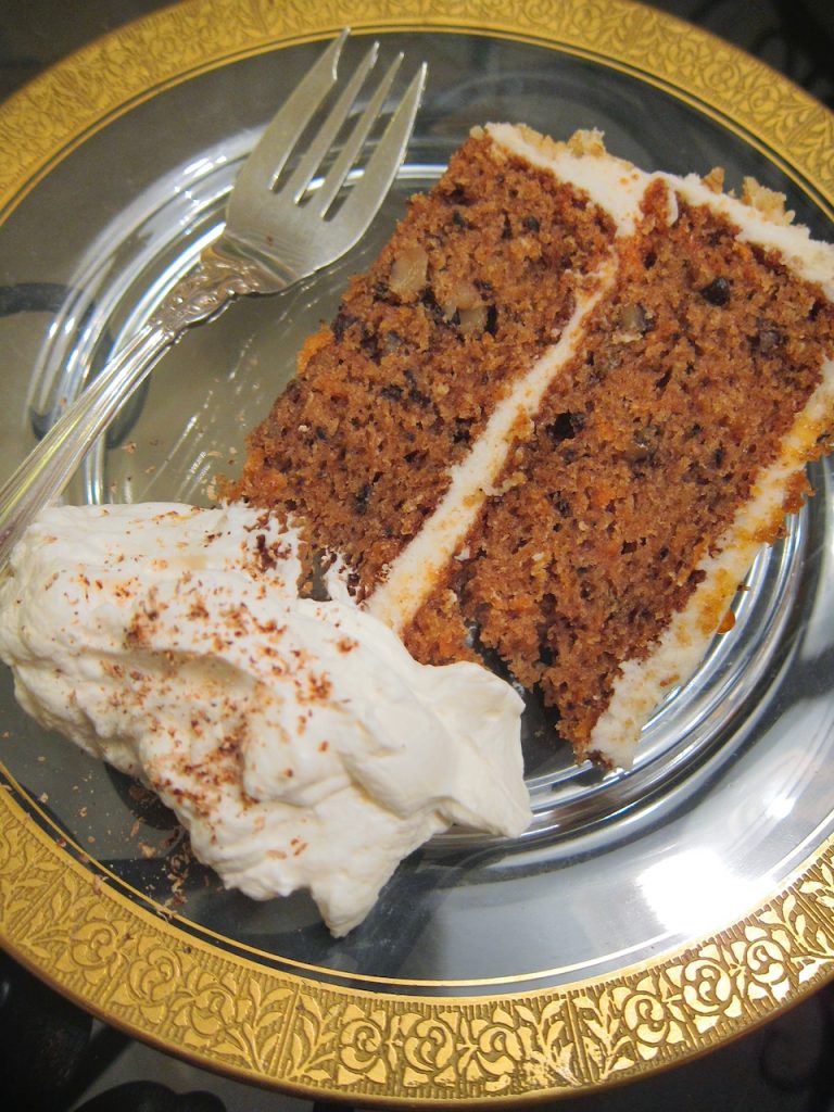 slice of carrot cake with spiced whipped cream