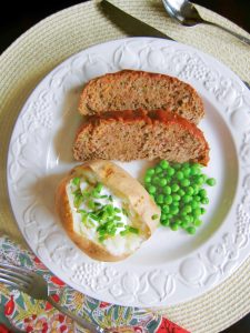 classic meatloaf with peas and baked potato