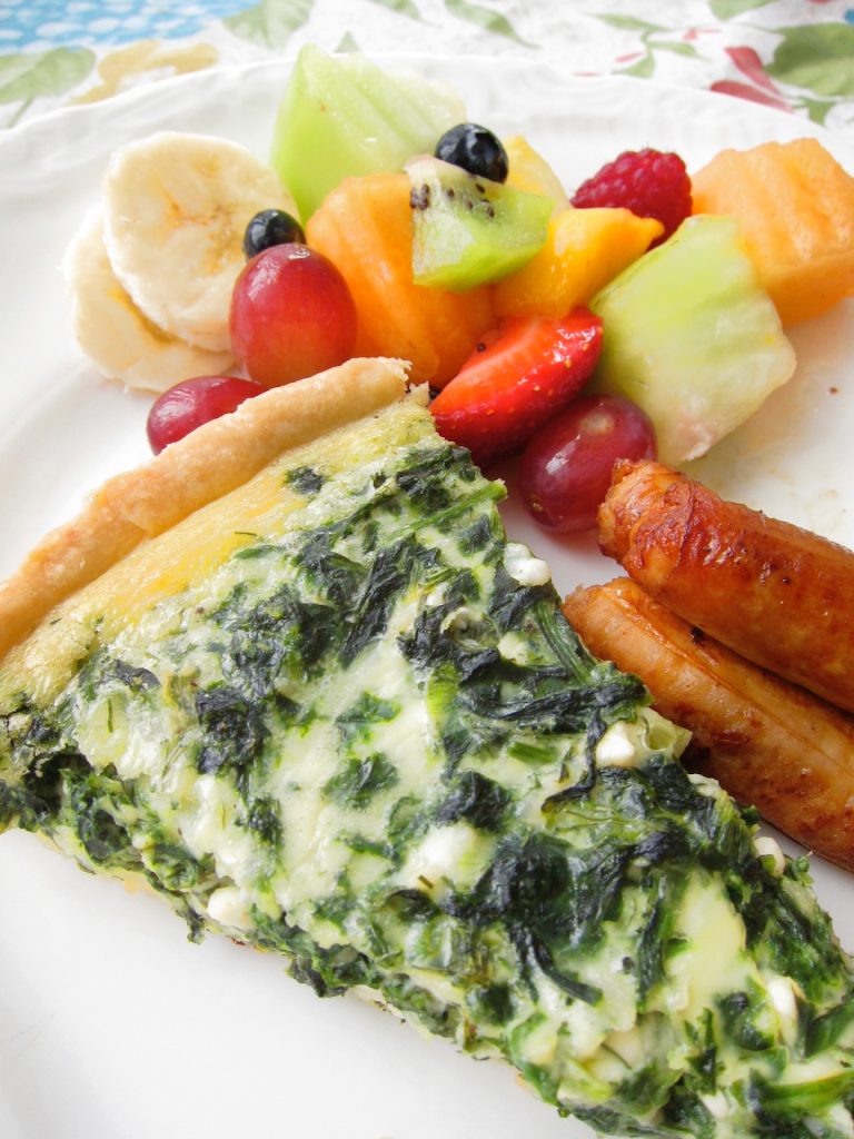 serving of quiche and fruit salad