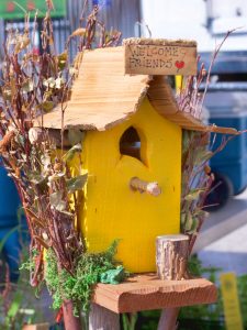 yellow birdhouse at the farmers market