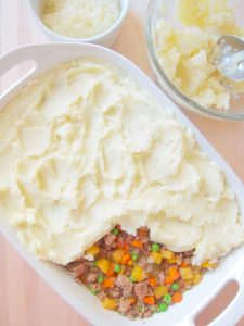 putting the mashed topping on Shepherd's Pie