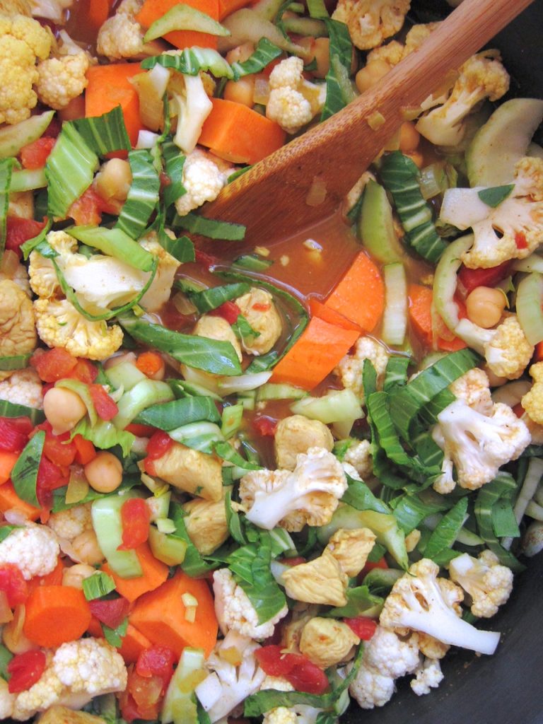 preparing Indian Curry With Sweet Potato and Bok Choy