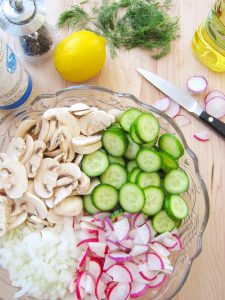 preparing Cucumber Salad With Mushrooms and Radishes