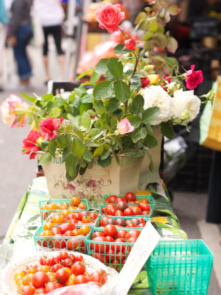 roses and tomatoes on table