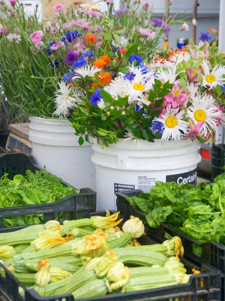 squash and flowers at the farmers market