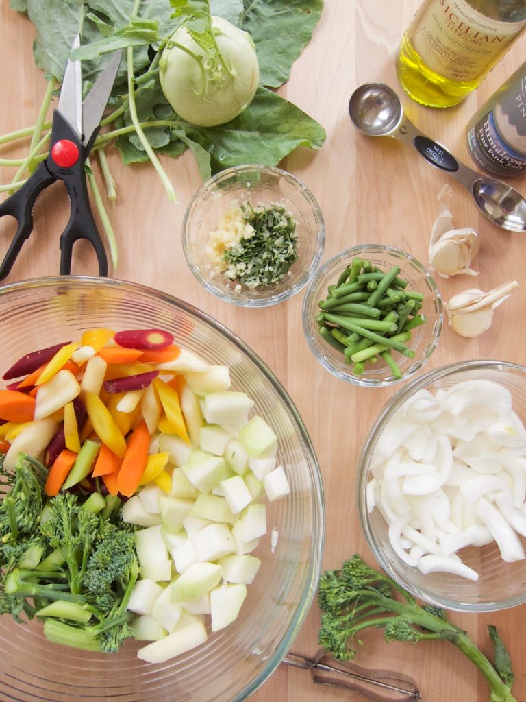 preparing Roasted Carrots, Kohlrabi and Baby Broccoli With Garlic Scapes