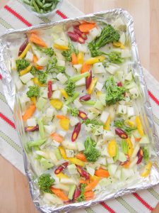 prepared vegetables on baking sheet