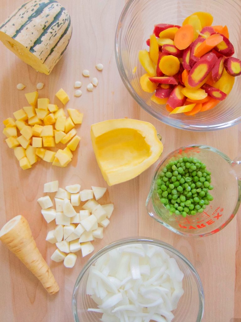 preparing Maple Roasted Delicata, Carrots, Parsnips and Peas