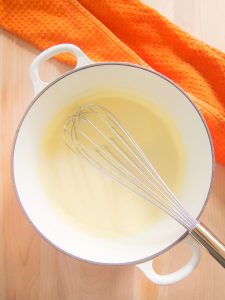 whisking alfredo sauce