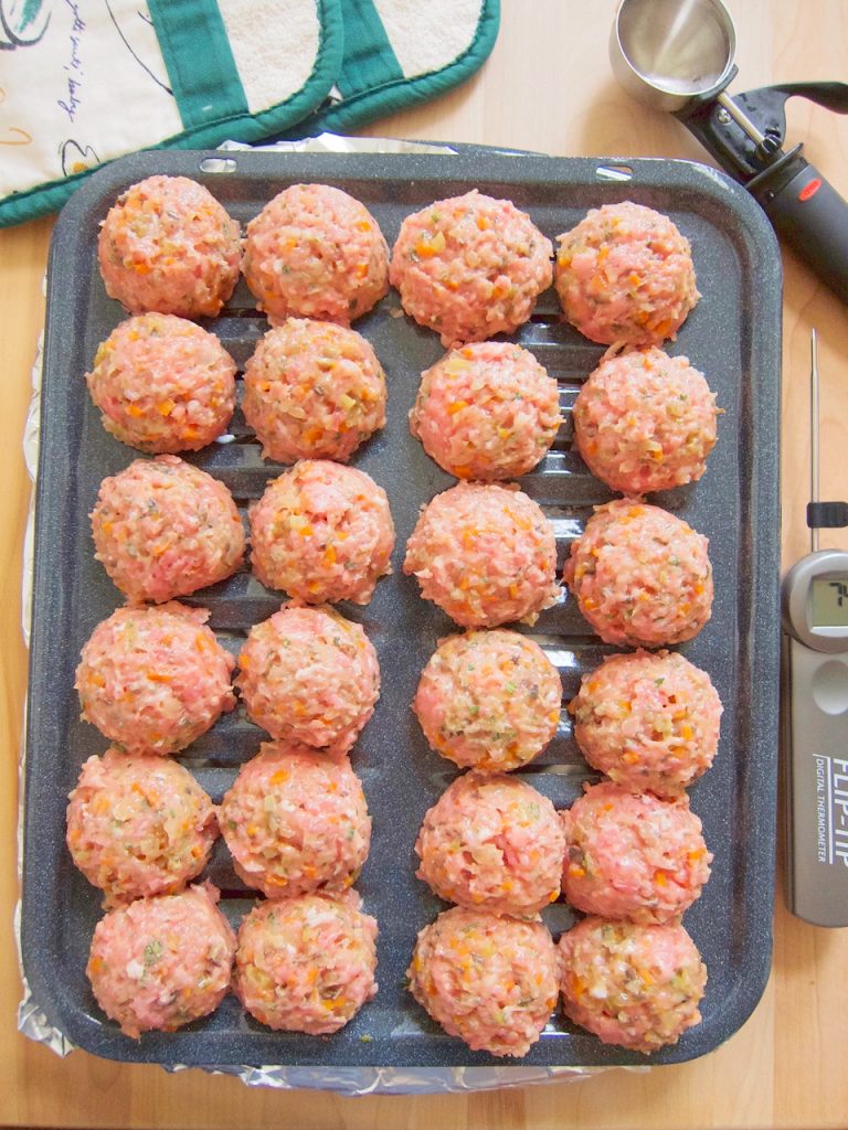 raw meatballs on roasting pan