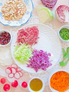 assembling Cabbage and Carrot Salad With Cranberries, Mint and Almonds