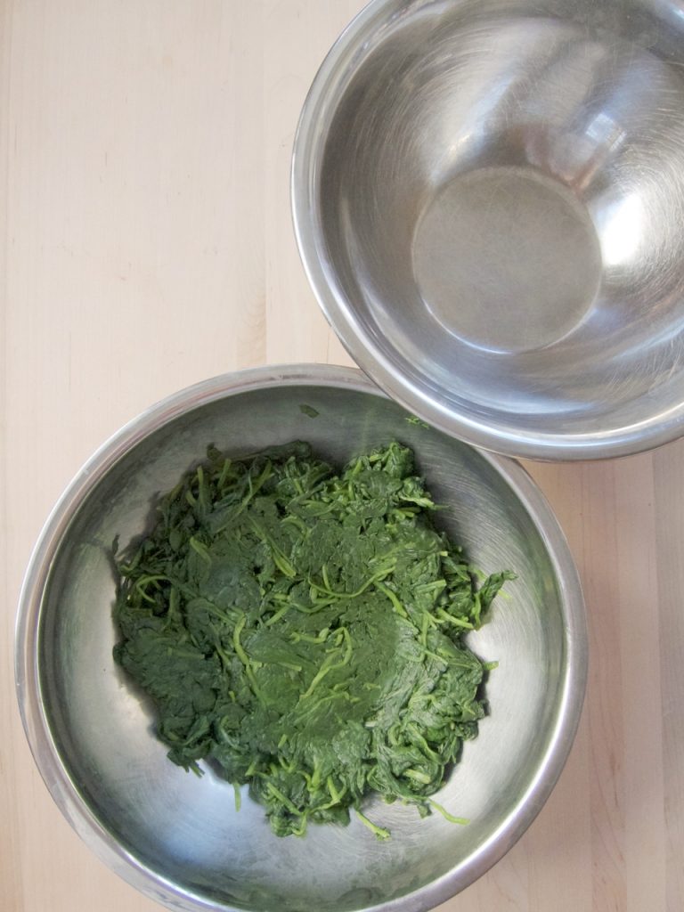 pressing the juice out of spinach
